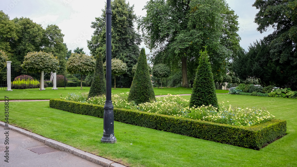 A park with trees and flowers in a city A park with trees and flowers in a city