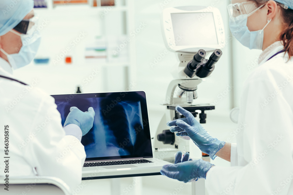close up. attending doctors discussing x-rays in the laboratory. close up. attending doctors discussing x-rays in the laboratory.
