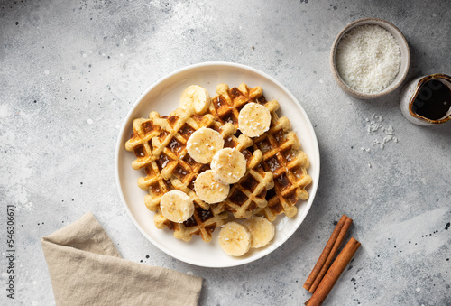 Healthy banana oatmeal waffles on white plate. healthy food concept. top view, copy space