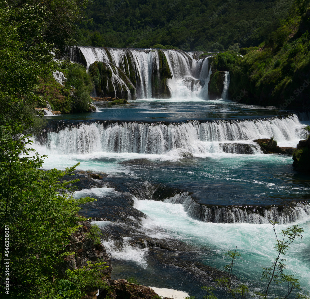 Fototapeta premium Beautiful river waterfall landscape nature in summer clear water and forest. 
