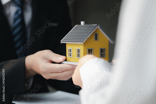 The salesperson of the housing estate in the project is preparing and verifying the contract of sale for the customer who will enter the contract. Concept of selling housing estates and real estate.