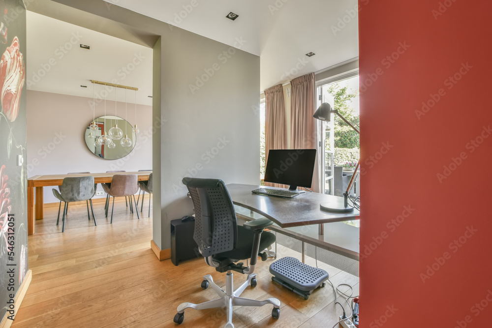 Desk by a bright window with color walls Desk by a bright window with color walls