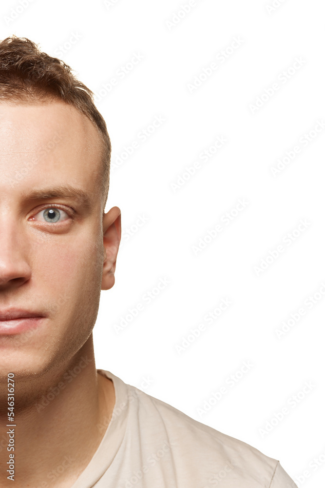 Half-face portrait of young man with shaved face and smooth perfect skin isolated over white studio background. Concept of men's health Half-face portrait of young man with shaved face and smooth perfect skin isolated over white studio background. Concept of men's health