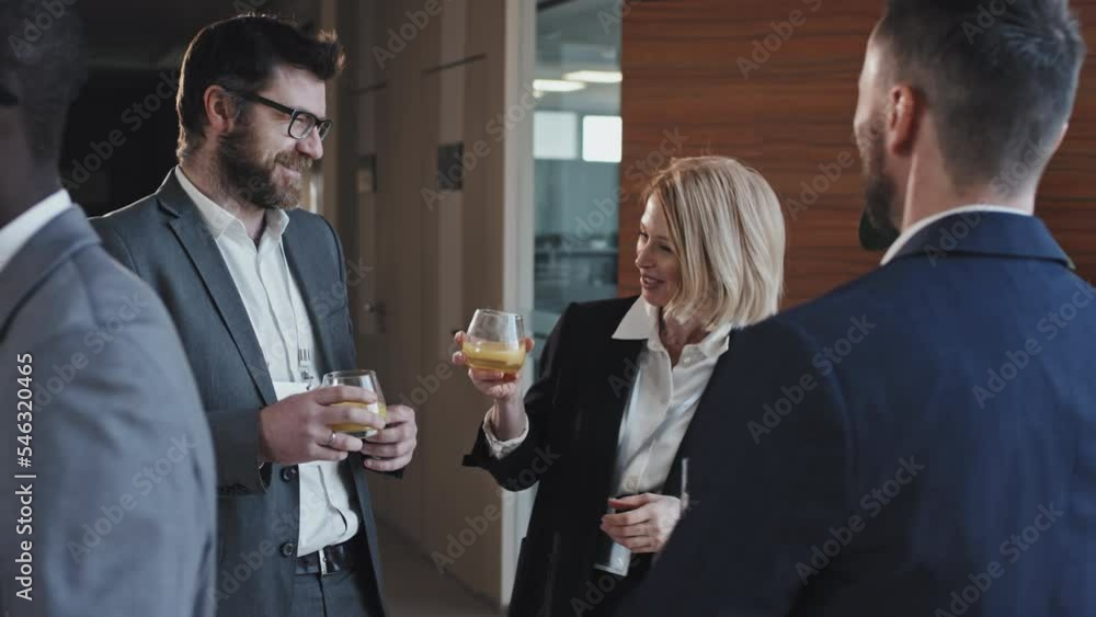Slow motion of successful business people enjoying small party after conference or project presentation Slow motion of successful business people enjoying small party after conference or project presentation