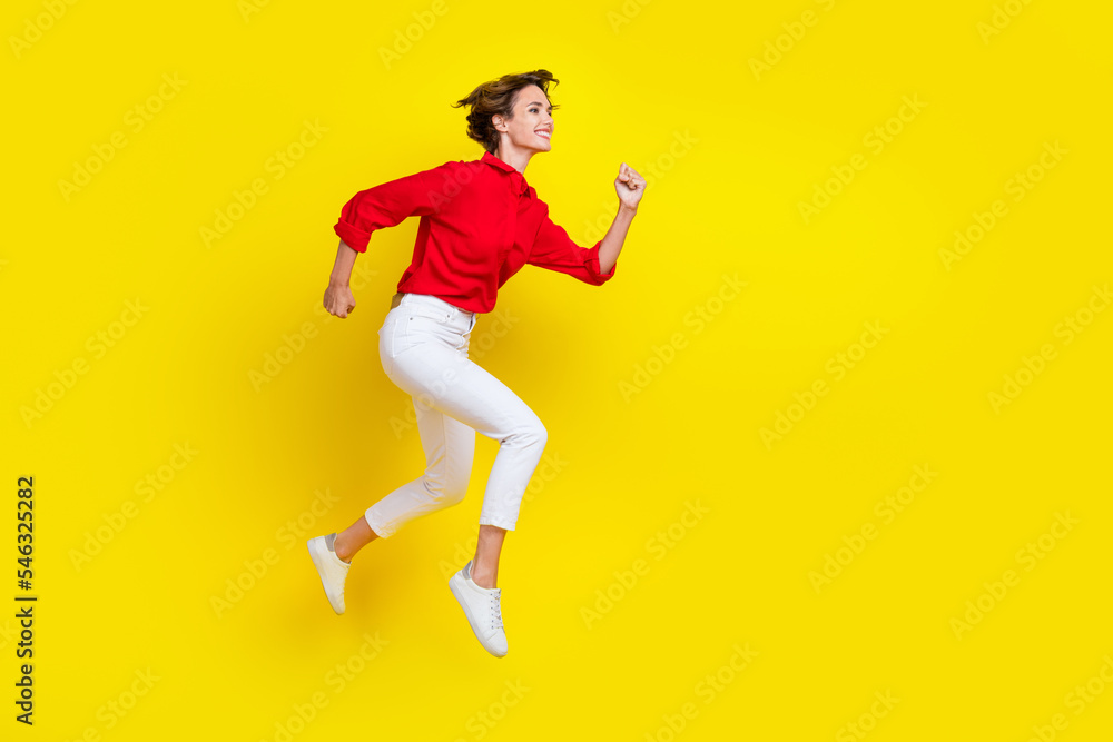 Full length profile portrait of active sportive person running jump isolated on yellow color background