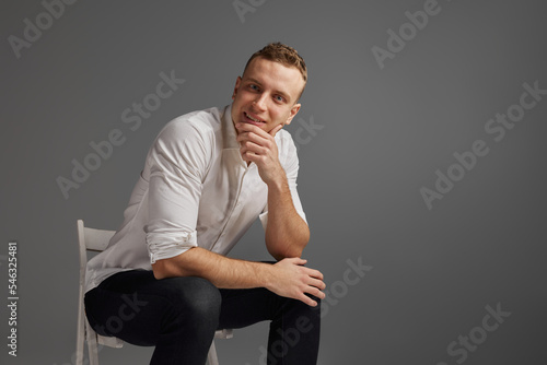 Portrait of young man, businessman posing in white shirt isolate dover grey studio background. Professional training courses