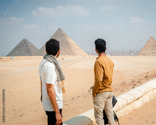 friends exploring giza pyramids in cairo egypt photo