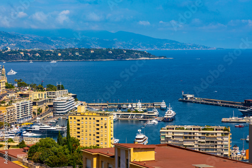 Panoramic view of Monaco metropolitan area with Monte Carlo, Carrieres Malbousquet and Les Revoires quarters over Hercules Port at French Riviera coast photo