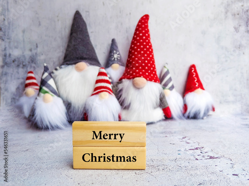 Wooden Cubes with Merry Christmas Text and Christmas Dwarfs . Greeting Card with Christmas Elf