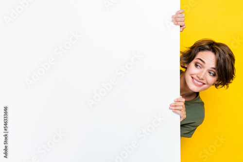 Photo of nice cute pretty lady wear stylish clothes hand hold empty space look cool proposition novelty isolated on yellow color background