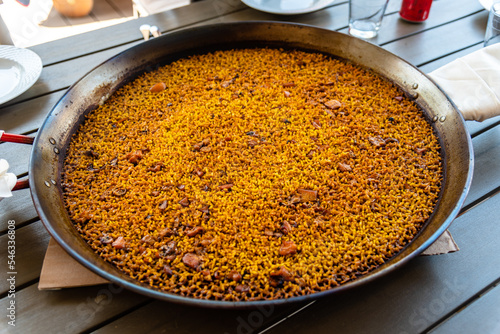 Seafood Paella. Arroz a banda or arros a banda is a traditional Spanish food with rice cooked in fish stock, containing peeled prawns, grouper or chopped squid, typical of the coastal area of Alicante