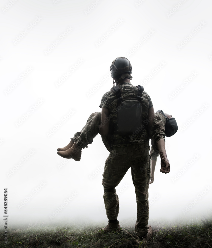 The commander carries a wounded soldier The commander carries a wounded soldier