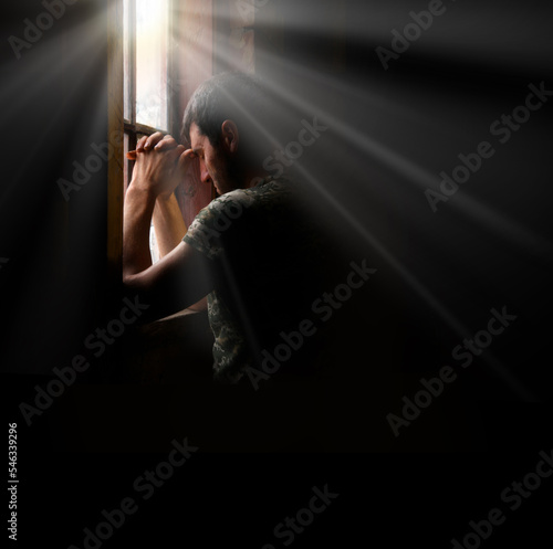 Obraz na płótnie Sad soldier praying at the window