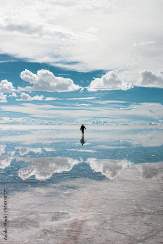 Woman enjoying her vacations in the Salar de Uyuni, connecting with nature in Bolivia.