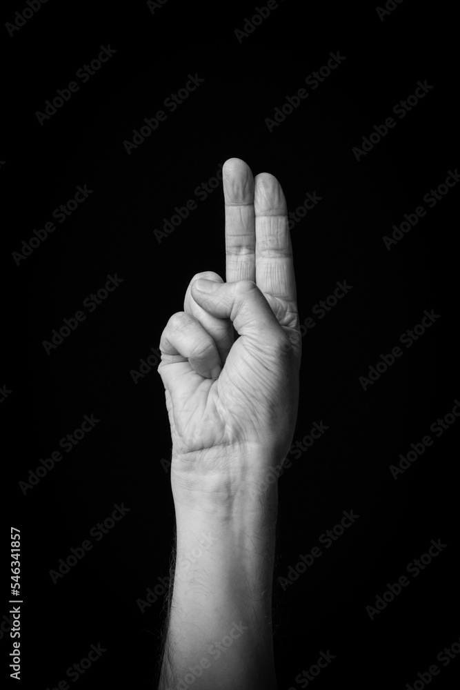 Hand demonstrating the Arabic sign language letter 'ت' or 'TA' Hand demonstrating the Arabic sign language letter 'ت' or 'TA'
