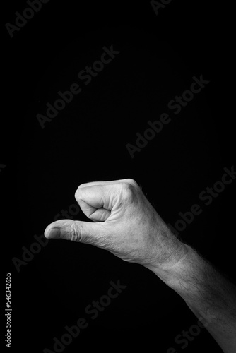 Hand demonstrating the Arabic sign language letter 'و' or 'Waw'