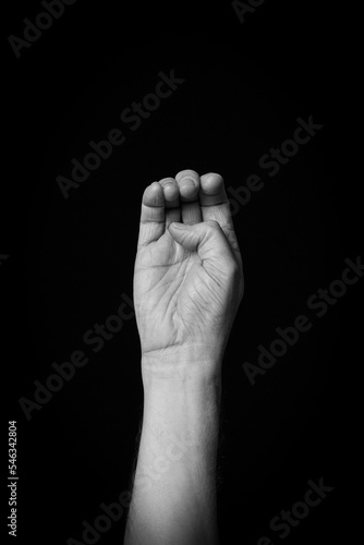 Hand demonstrating the Arabic sign language letter 'ج' or 'Jiem'