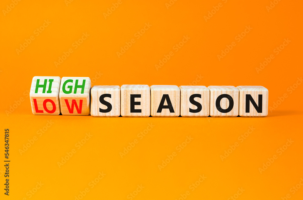 High or low season symbol. Concept words High season and Low season on wooden cubes. Beautiful orange table orange background. Business high or low season concept. Copy space. High or low season symbol. Concept words High season and Low season on wooden cubes. Beautiful orange table orange background. Business high or low season concept. Copy space.