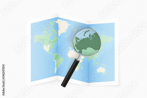 Enlarge Russia with a magnifying glass on a folded map of the world.