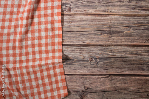 orange tablecloth on vintage wooden table