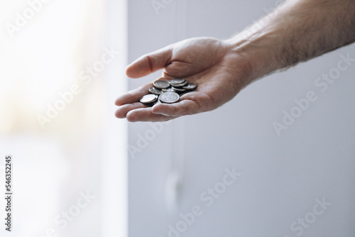 Hand holds bunch of coins money of ukraine. Currency of Ukraine. Ukrainian hryvnia pennies.