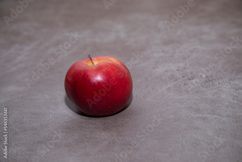 one apple on the wooden background