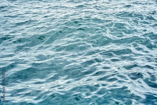 Closeup seascape surface of blue sea water with small ripple waves on an overcast day