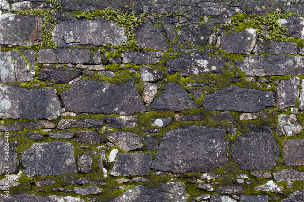 Mossy rustic stone wall texture