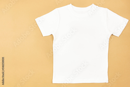 White womens cotton tshirt mockup on craft paper background. Design t shirt template, print presentation mock up. Top view flat lay. 