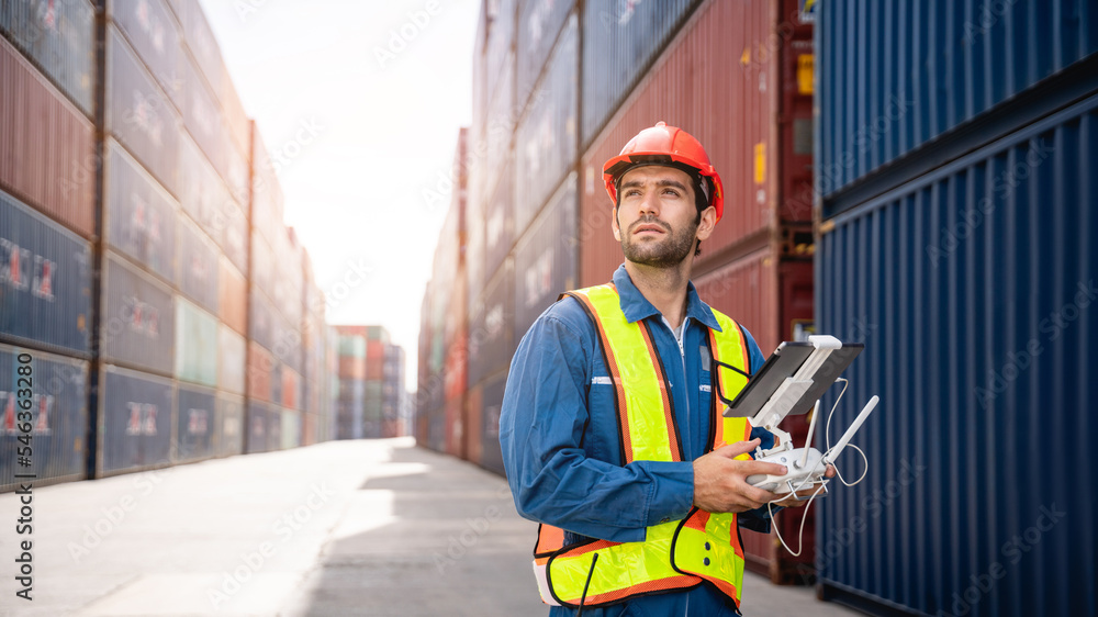 A foreman or worker pilots a drone at a container port used a remote controller for checking container.