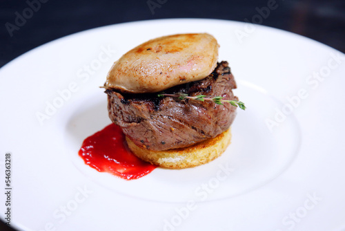 Tournedos Rossini. Foie gras, Black Angus beef tenderloin, with red wine sauce. Fillet mignon steak with Foie Gras. photo