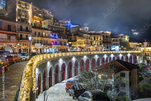 The village of Arachova, Greece, next to the mountain Paranssus during a cold winter night with Christmas decoration lights photo