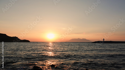 Sea port view, lighthouse, mountains and the opposite island of Samothrace in Gökçeada, Imbros Island at sunset	 photo