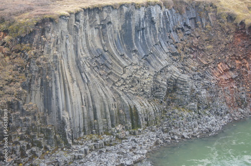 Autumn in the Studlagil Canyon - Basalt Rock Columns and Glacial River Jokuldalur, East Iceland photo