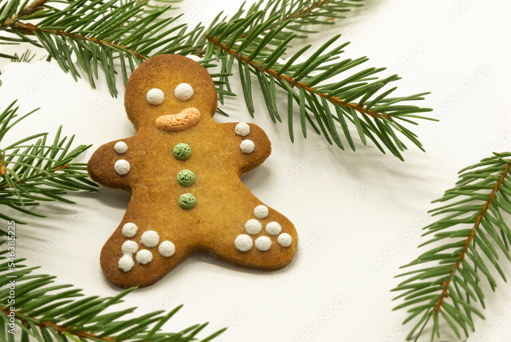 gingerbread man cookies decorated with royal icing, with icing sugar and fir branh on white background. Christmas food, pastry background. New Year theme. Merry Christmas and Happy New Year Holidays gingerbread man cookies decorated with royal icing, with icing sugar and fir branh on white background. Christmas food, pastry background. New Year theme. Merry Christmas and Happy New Year Holidays