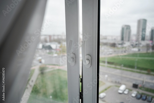 Obraz na plátně Window with plastic frame and white curtain is open