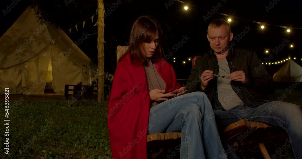 Man joke for lovely wife and having fun night time near their tent with lighting during romantic trip Man joke for lovely wife and having fun night time near their tent with lighting during romantic trip