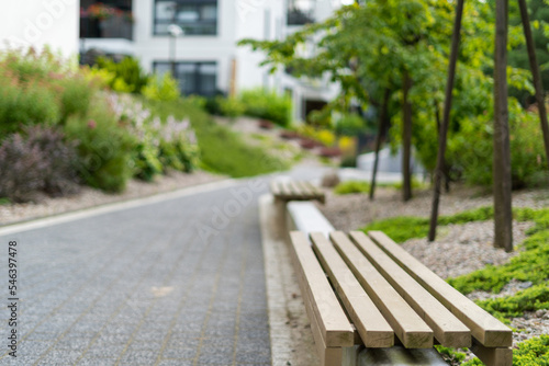 Wooden bench in recreation area near modern office building © brizmaker