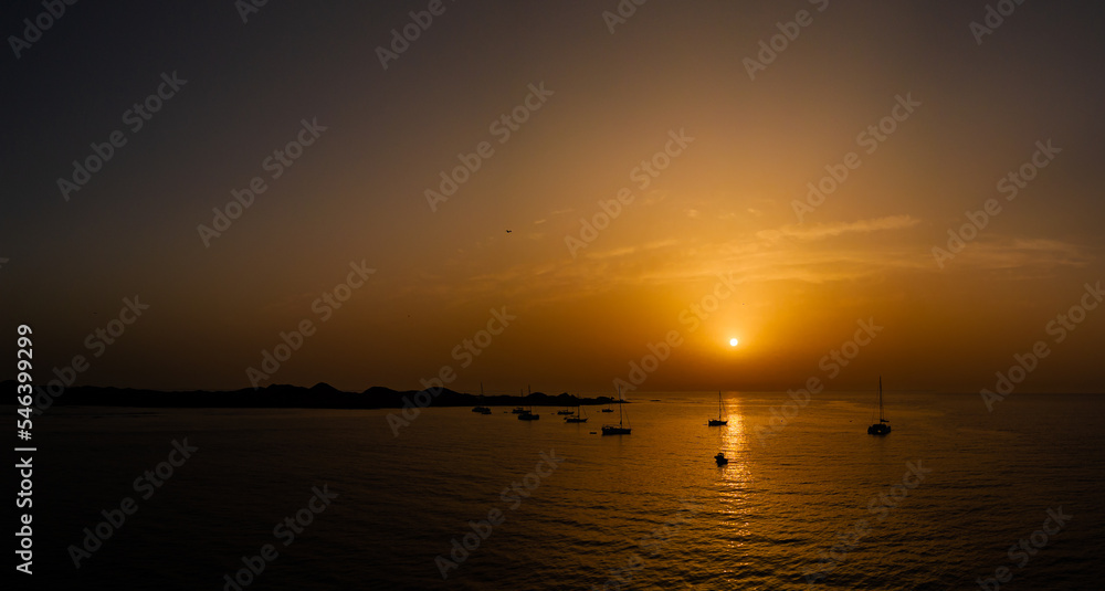 Stunning low level aerial image of the yachts, boats, moored off the island of Lobos at sunrise near Corralejo Fuerteventura