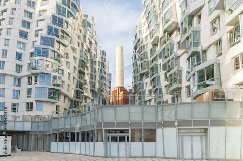 One of four chimneys of iconic London landmark Battersea Power Station and surrounding area with appartments and offices.