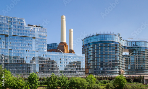 View at two of four chimneys of iconic London landmark Battersea Power Station and surrounding area with modern apartments and offices.