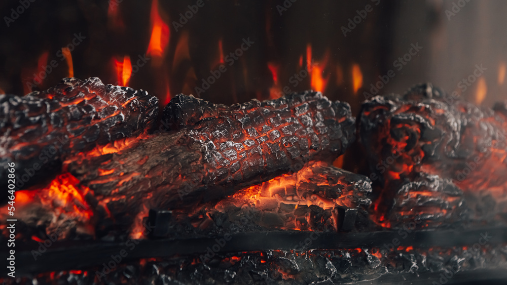 Artificial imitation of fire, electric bright fireplace with fake sparkling  red orange and yellow flame. Modern decoration at home. Close up heating  burning logs Stock Photo | Adobe Stock