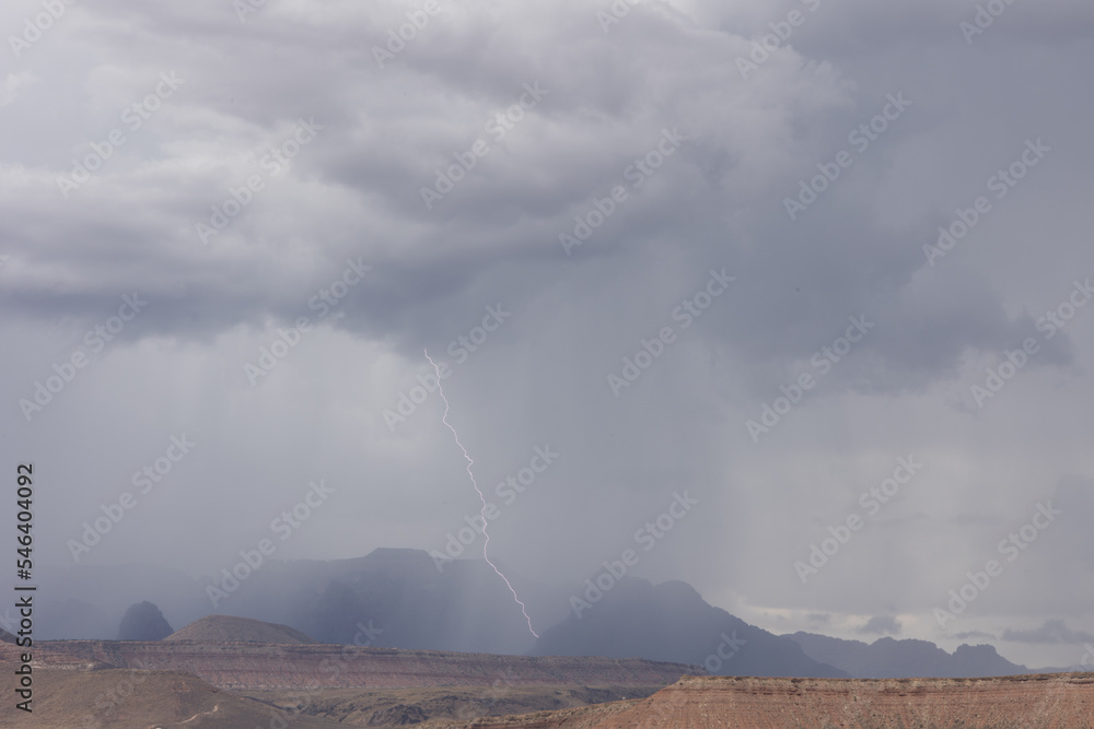 Φωτογραφία A bolt of cloud to ground lightning strikes near West Temple mountain in Zion National park Utah during a summer thunderstorm