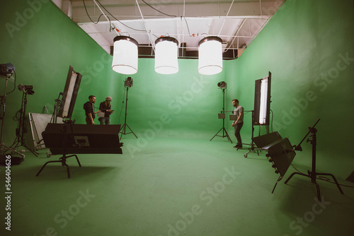 Film set, monitors and modern shooting equipment. Film crew, lighting devices, monitors, playbacks - filming equipment and a team of specialists photo