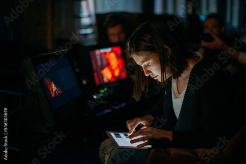 Director at work on the set. The director works with a group or with a playback while filming a movie, advertising, or a TV series. Shooting shift, equipment and group.