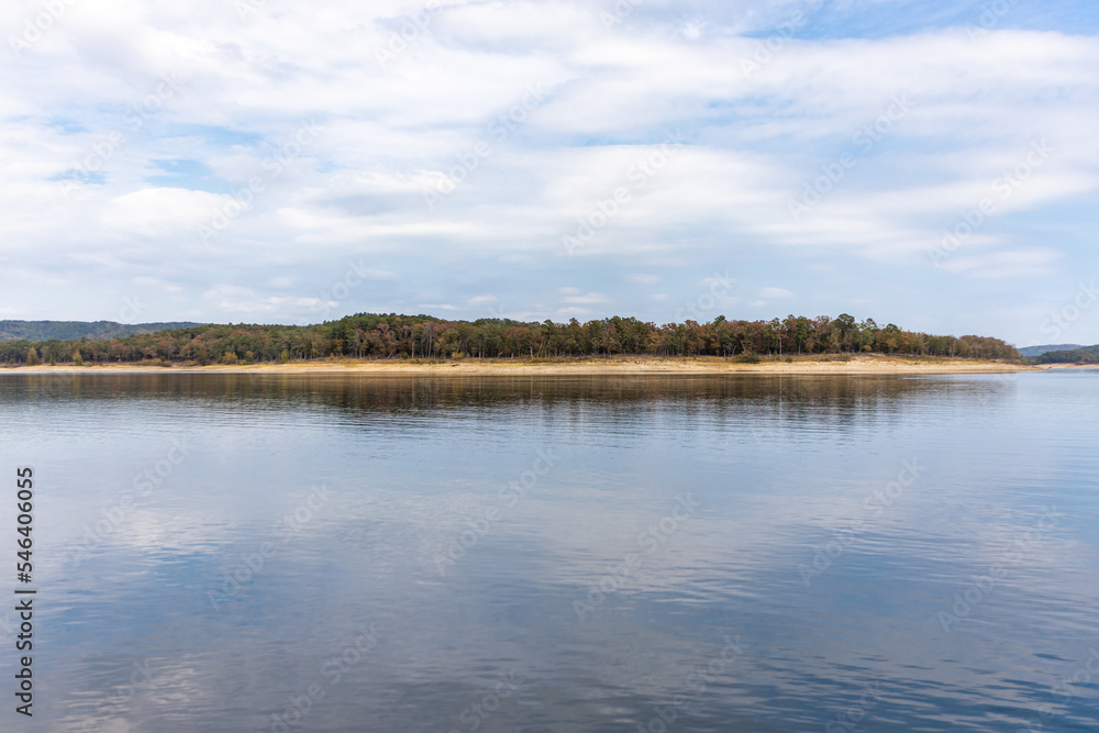 Beautiful landscape with blue sky and smooth lake surface, forest and coastline in the distance, Broken bow lake, Oklahoma , USA. Beautiful landscape with blue sky and smooth lake surface, forest and coastline in the distance, Broken bow lake, Oklahoma , USA.