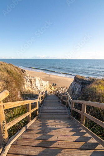 One of the most beautiful beaches in Spain, called (Cuesta Maneli, Huelva) in Spain.  Surrounded by dunes, vegetation and cliffs.  A gorgeous beach. photo