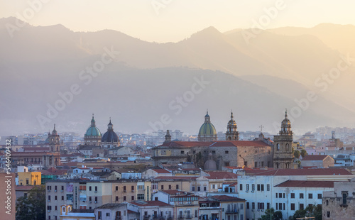 Residential Homes and Historic Church Buildings with mountains in background in Palermo, Sicily, Italy. Sunny Sunset Sky. © edb3_16