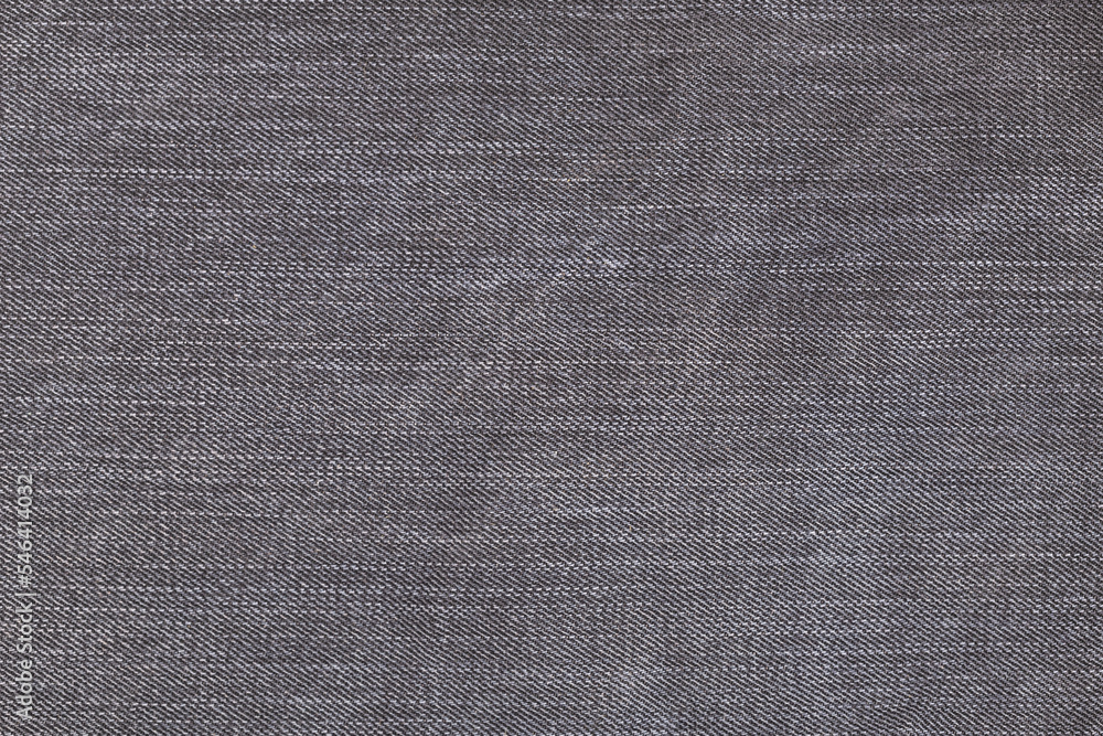 Fototapeta premium A denium gray jean closeup, background with space for text. View of old jeans details. Denim background, texture