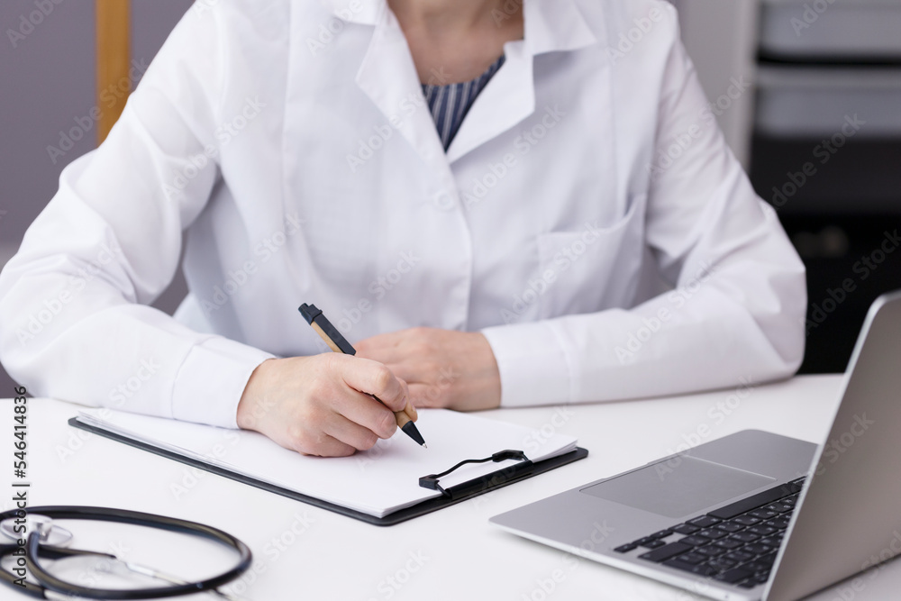 The doctor writes data on paper and works with patients in the hospital. The doctor writes data on paper and works with patients in the hospital.